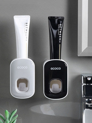 Two ecoco mouthwash dispensers, one white and one black, on a gray surface.