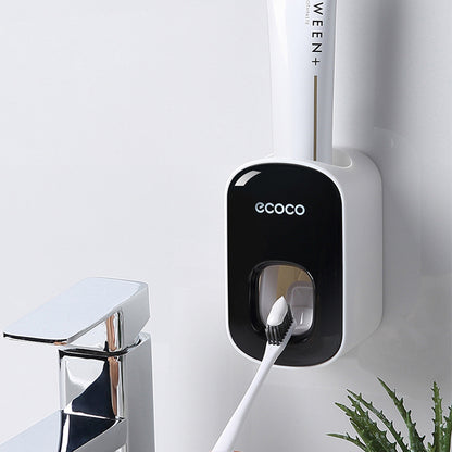 White toothbrush with black handle attached to a wall-mounted holder labeled 'ecoco' on a white background.